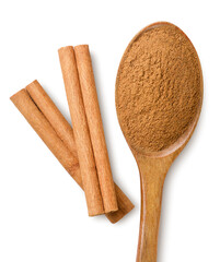 Cinnamon powder in a spoon and sticks close-up on a white. Top view