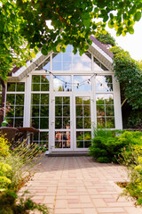 Building with glass windows surrounded by plants
