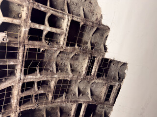 Damaged roof. Close up photo of metal framing elements and white plaster covering roof support. Concept for roof repair. Unsightly finish with broken ceiling is being repaired