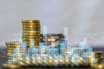 Close-up of stacked coins with digital financial charts and graphs. Concept of investment growth, stock market analysis, profit, savings, fintech, ROI and economic success