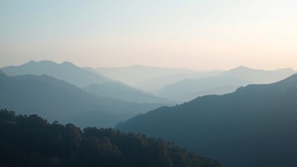 A serene mountain landscape with rolling hills and a clear sky at sunrise