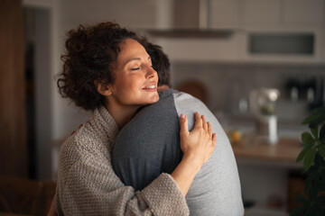 Warm Embrace At Home: Woman And Man Share Tender Hug For Comfort And Connection