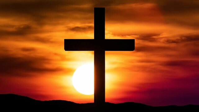 Silhouette of Christian cross stands prominently against vibrant sunset sky, symbolizing faith, hope, and spiritual worship. This powerful scene serves well for religious video footage.