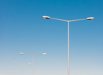 Minimalist Street Lamps Against Clear Blue Sky