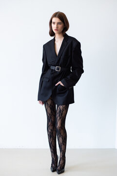 Professional fashion model wearing stylish trench coat posing in studio, full length female portrait for modeling agency portfolio, commercial beauty and modern style photography