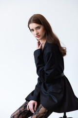 Professional fashion model wearing stylish trench coat posing in studio, full length female portrait for modeling agency portfolio, commercial beauty and modern style photography