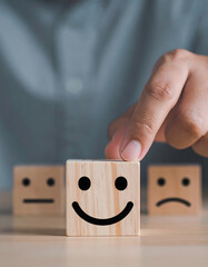Choosing Happiness - Hand Picking Smiling Face from Negative Emotion Blocks
