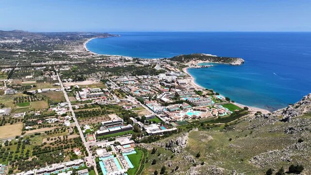 Aerial drone cinematic video of famous for luxury pool resorts and five star hotels seaside village of Kolymbia, Rhodes island, Dodecanese, Greece