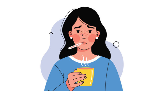 Sick young woman with a fever is measuring her temperature with a thermometer and holding a hot drink to feel better.