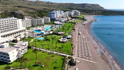Aerial drone cinematic video of beautiful sandy beach of Kalithea in the west coast of Rhodes island well known for luxury hotels and resorts, Dodecanese, Greece