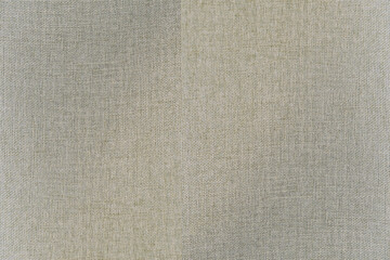 Weave pattern of light tan textile. Abstract fabric texture for background, wallpaper, decor, or design element with subtle horizontal and vertical lines.
