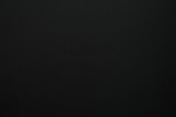 Simple dark background with subtle texture. Minimalist black surface for product display, branding, or abstract wallpaper. Solid color for design element.