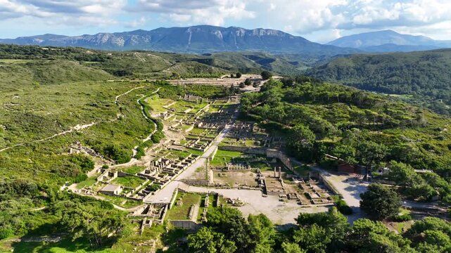 Aerial drone cinematic video of iconic archaeological site of former hillside city of Kameiros, overlooked by the columns of an acropolis dedicated to Athena, Rhodes island, Dodecanese, Greece
