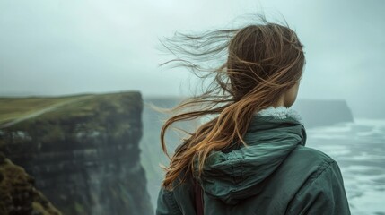 Woman gazing ocean cliff