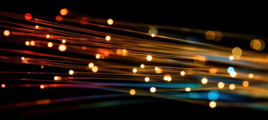 Vibrant Abstract Light Streaks and Sparkling Bokeh Particles on Dark, Evoking Digital Data Flow and Technology.