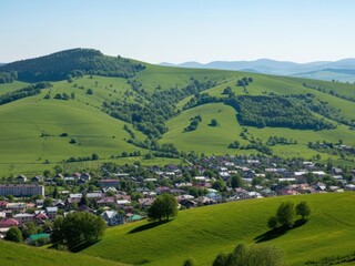 Obraz premium Aerial view of a picturesque village nestled in lush green hills with houses and trees
