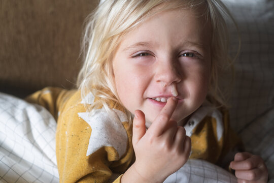 European 4 Year Old Blonde Girl Sick with Cold Resting at Home