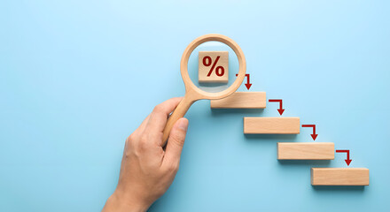 magnifying glass on wooden blocks with percentage sign