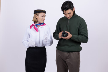 Man showing camera photos to a woman in uniform