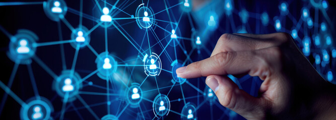 Digital Network Interaction: A fingertip interacts with a glowing digital network, symbolizing connection, collaboration, and the interconnectedness of information in the modern world.