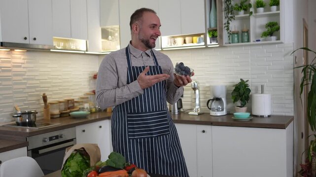 Food blogger showing fresh blueberries in the kitchen