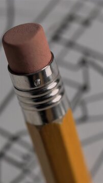Close-up of a pencil eraser on a blueprint.