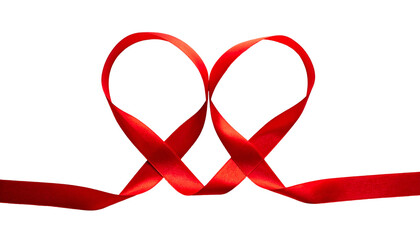 A red ribbon twisted and looped into a heart shape, against a stark black background