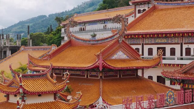 Penang landmark kek lok si temple highlighting massive bronze kuan yin statue, symbolizing divine compassion amid intricate architectural details. Translation: Temple of Supreme Bliss