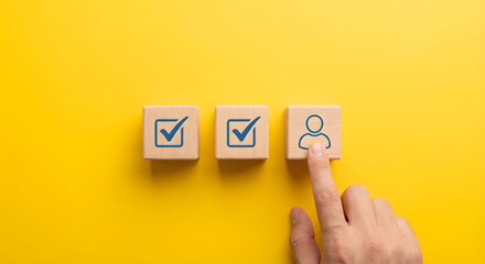 hand selecting user icon on wooden block