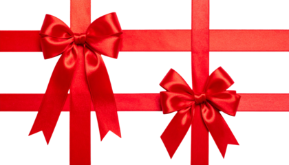 Two red satin ribbon bows on crossing ribbons, presented against a black background