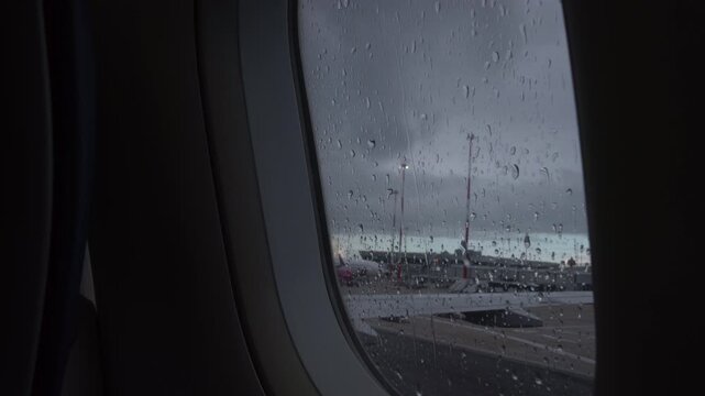 Aircraft Window with plane with rainy window and raindrops