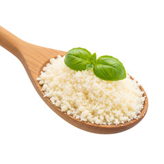 Crumbly feta cheese in wooden spoon with fresh basil leaves on top