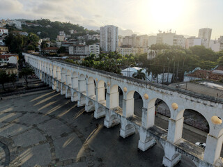 RIO DE JANEIRO, BRAZIL &ndash; NOVEMBER 2025: Aerial overhead shot of yellow tram riding on the top of Carioca Aqueduct (Arcos de Lapa), a famous landmark in old part of Rio de Janeiro, Brazil