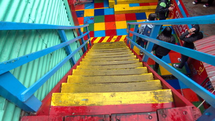 Yellow stairs and a checkerboard floor in a colorful gift shop in the La Boca neighborhood of Buenos Aires, Argentina
