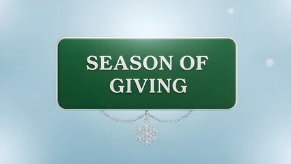 Festive green holiday sign prominently displaying the words season of giving with a hanging silver snowflake ornament symbolizing winter charity and goodwill against a soft blue background.