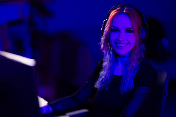 Young female gamer streaming online in a vibrant gaming setup