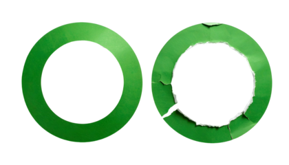 Two green circular paper cutouts, one intact, one torn and damaged, set against black