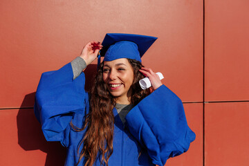 Young woman celebrating academic achievement with graduation cap and gown