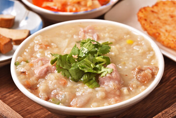 Brown rice porridge served with side dish on the table. 
