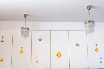 Beautiful interior view of villa kitchen with white cabinets decorated with festive Christmas stickers. Sweden.