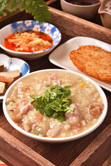 Brown rice porridge served with side dish on the table. 