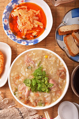 Brown rice porridge served with side dish on the table. 