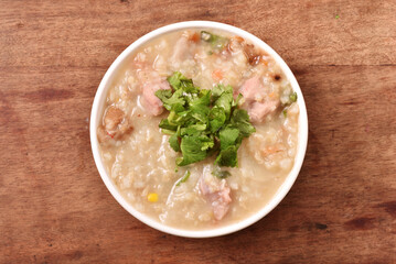 Brown rice porridge served with side dish on the table. 
