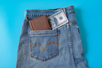 A brown pocket money in blue jeans pocket. Finances.