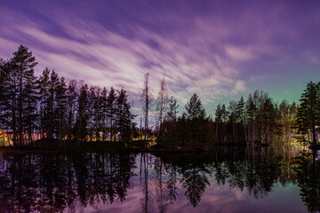 Nighttime Finnish Lake with Aurora Reflection under Purple Sky