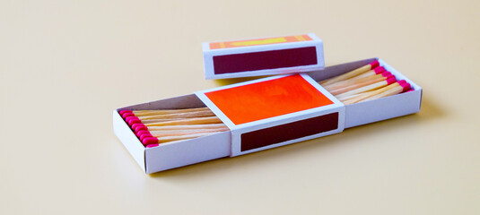 Pile of Wooden unused match stick in red box over the color background.
