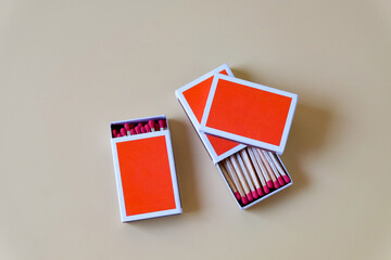 Pile of Wooden unused match stick in red box over the color background.