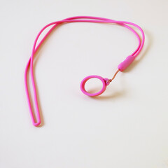 Pink eyeglass strap on color background.