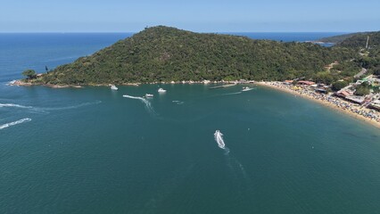 Aerial view of laranjeiras beach in santa catarina brazil with boats and lush greenery