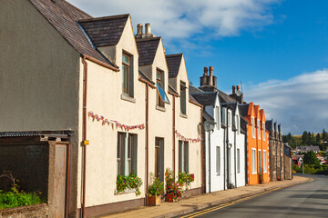 Colorful terraced houses along quiet street in Scottish village